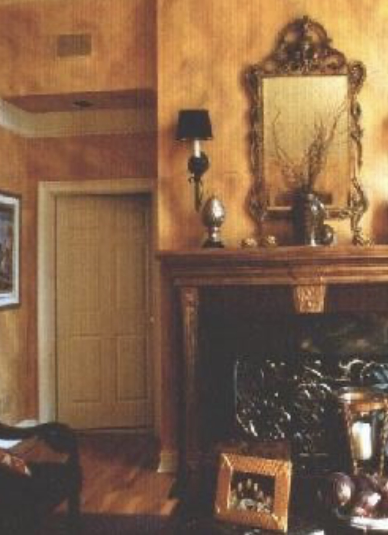 Warm amber faux finish living room with carved mantel and gilded mirror